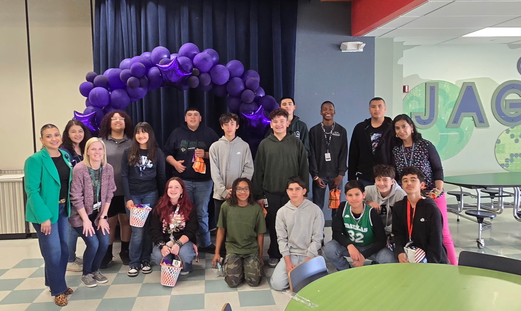 Richardson Middle School students who won in the March Madness Attendance Challenge take group photo with staff and goody bags