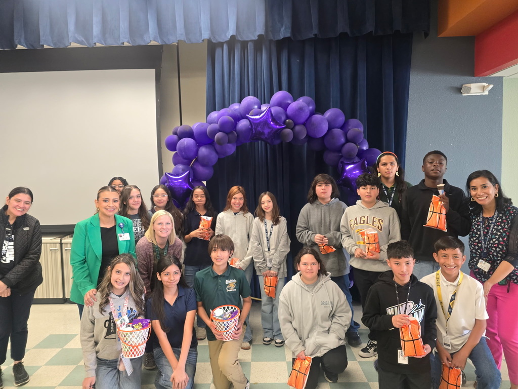 Richardson Middle School students who won in the March Madness Attendance Challenge take group photo with staff and goody bags