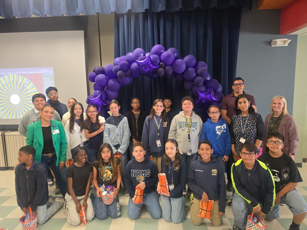 Richardson Middle School students who won in the March Madness Attendance Challenge take group photo with staff and goody bags