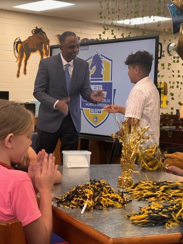 Mayor Renard Johnson shakes hands with Team of Excellence Award winner Nicolas Ontiveros Arrieta