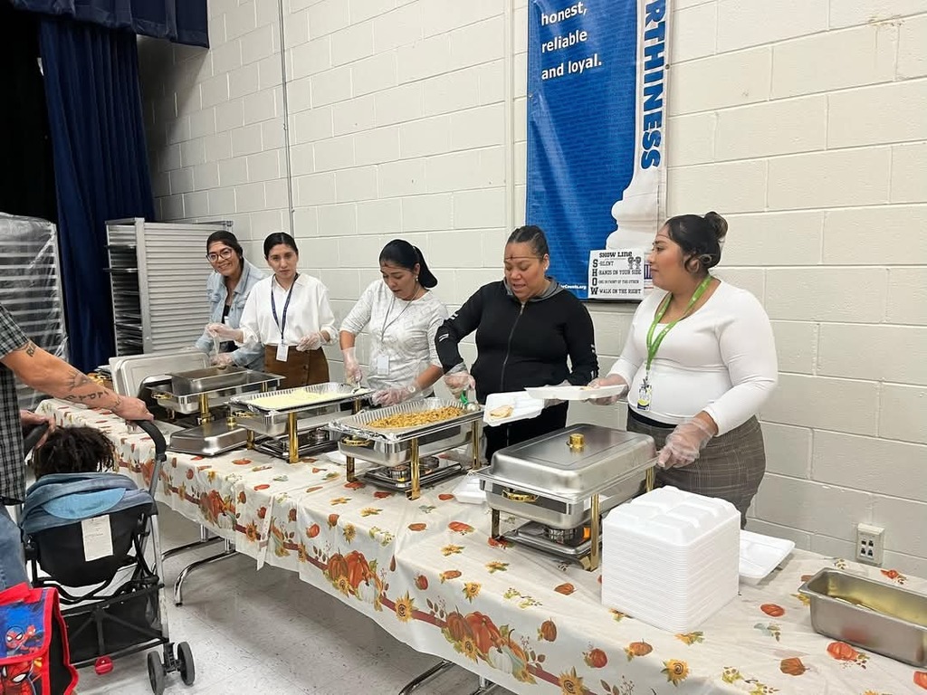 Volunteers serve food during Thanksgiving lunch