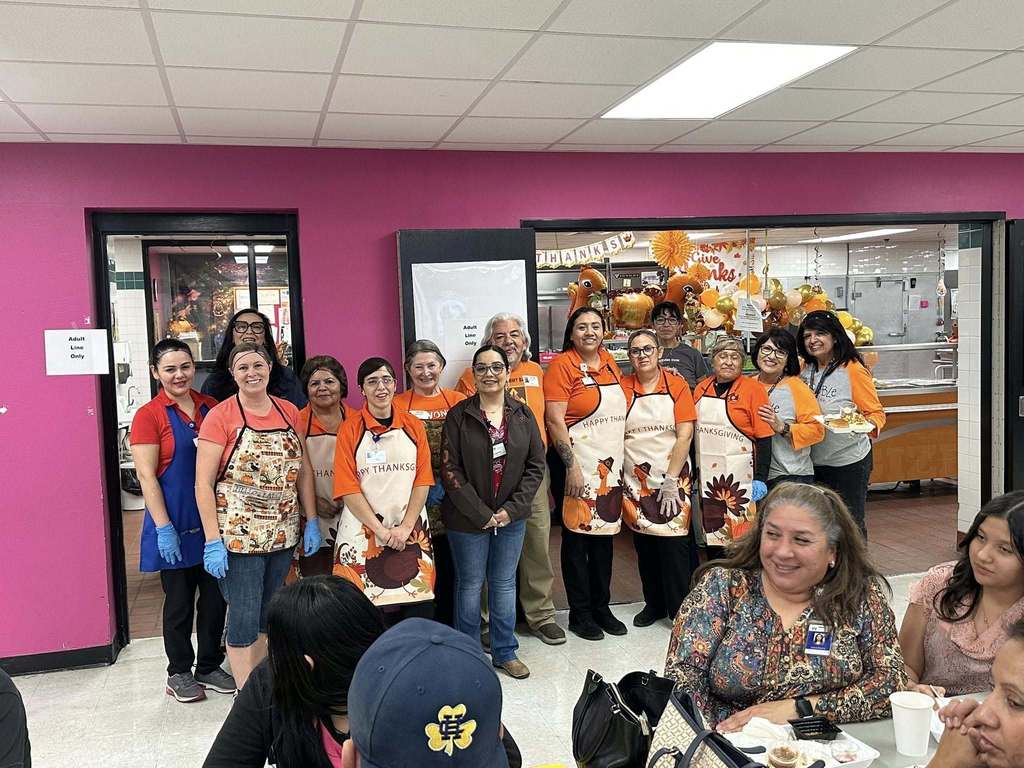 VIPS at Young Women's Academy take group photo during Thanksgiving lunch