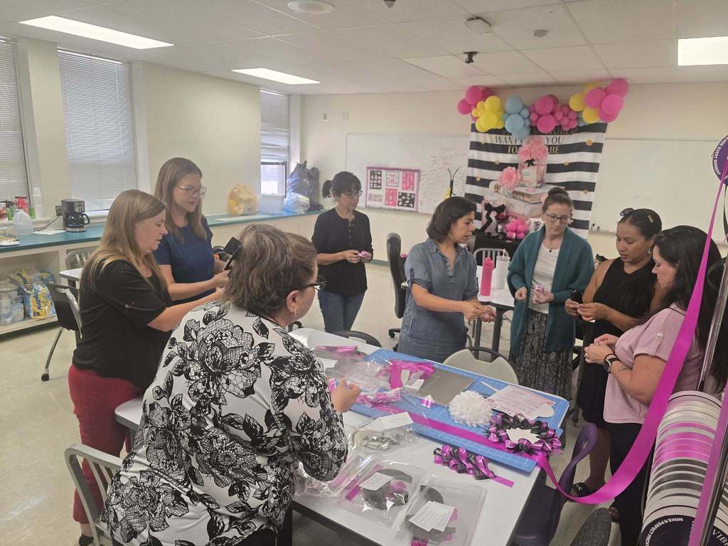 Volunteers organize classroom materials