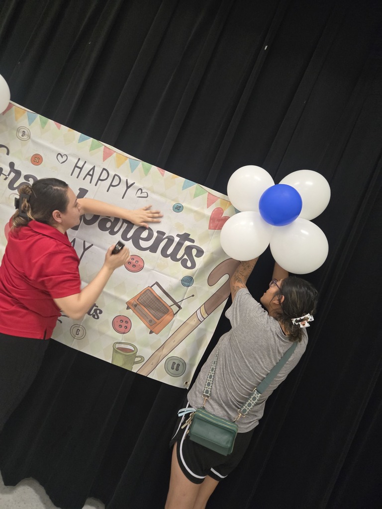 volunteers hang banner and balloons for Grandparents Day