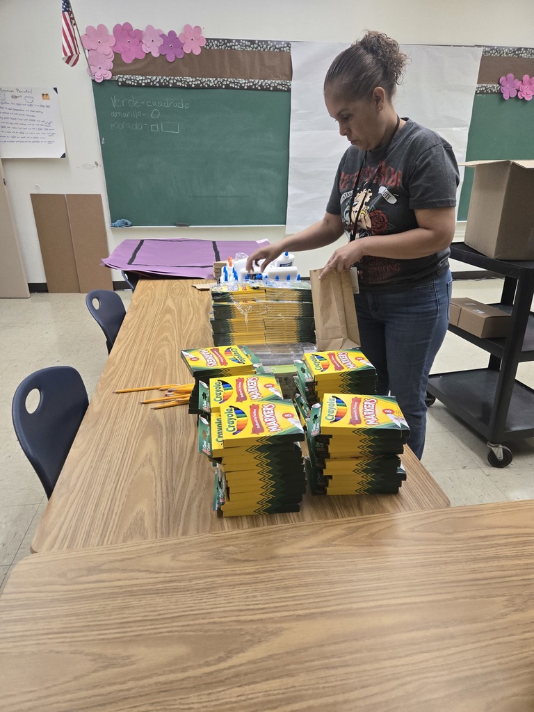 Volunteer organizes classroom materials