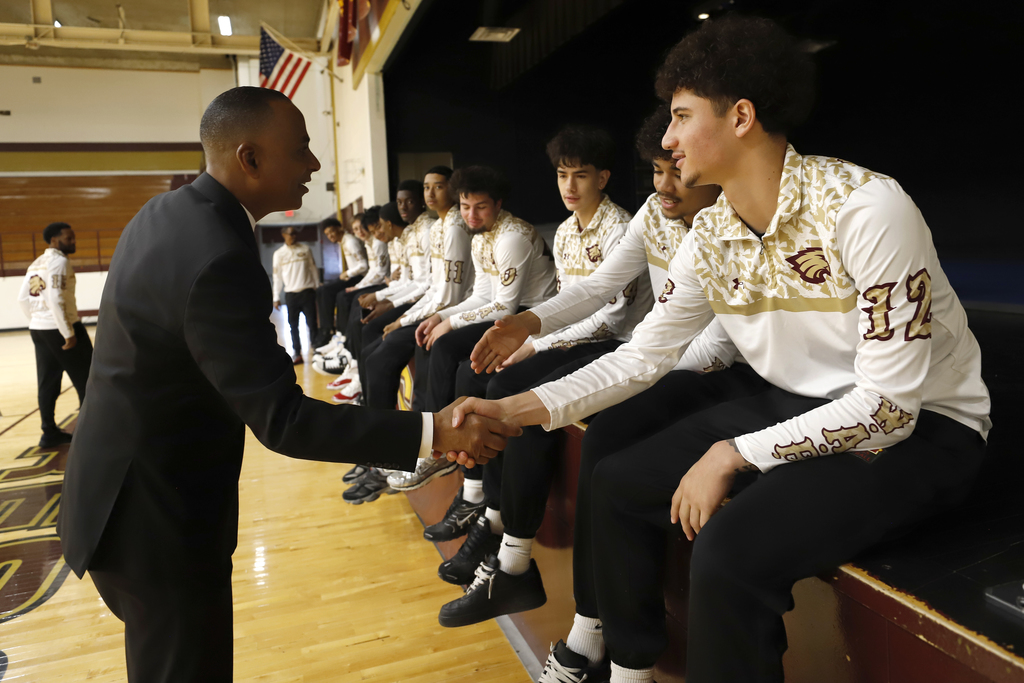 Mayor Renard Johnson shake hands with Andress High School basketball players