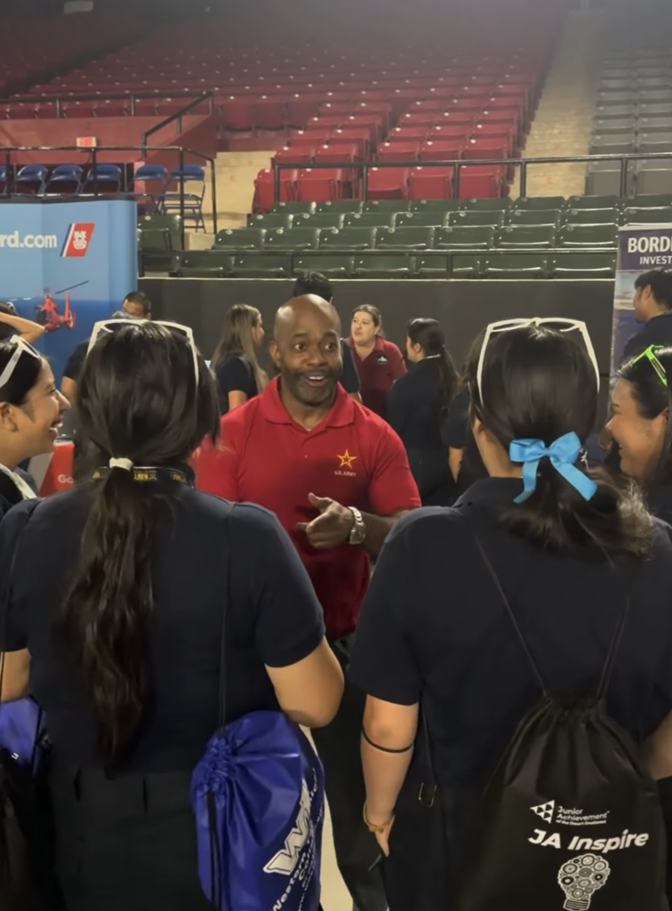 Army recruiter talking with students