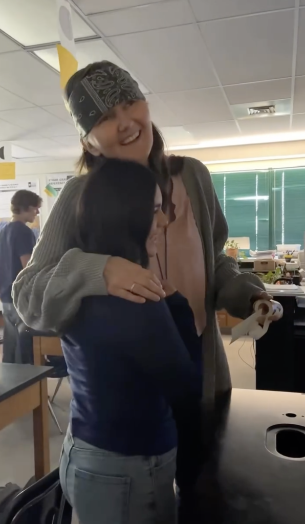 teacher hugging student