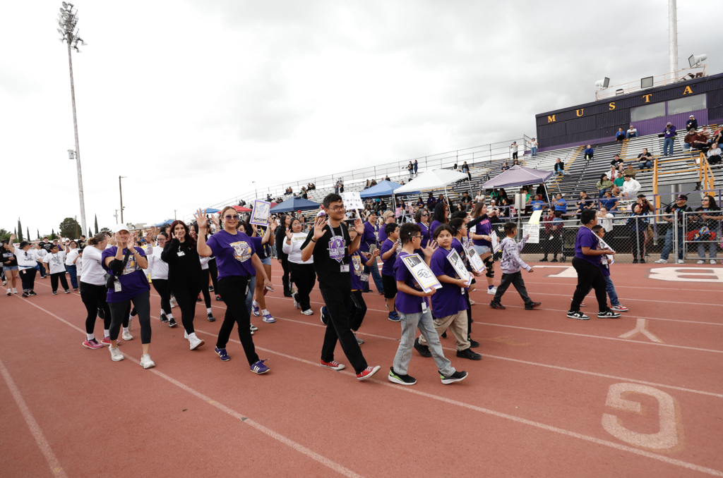 Unidos Game Parade Hartley PK-8 school waving