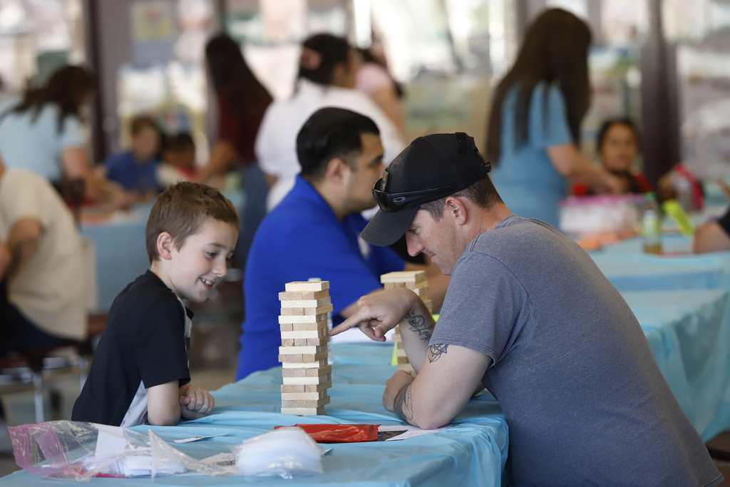 Parent and student play jenga