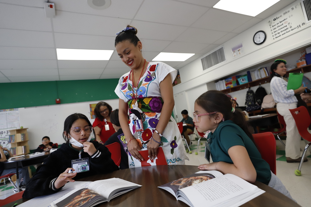 Teacher helping students during class