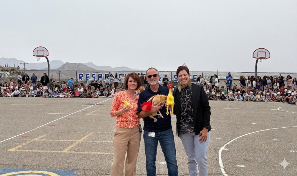 Principal Belknap and staff members take photo in front of students