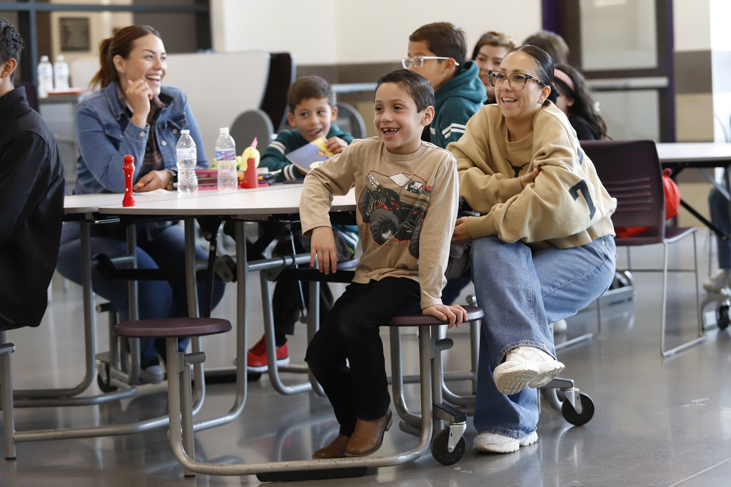 Families sitting at a table laughing together