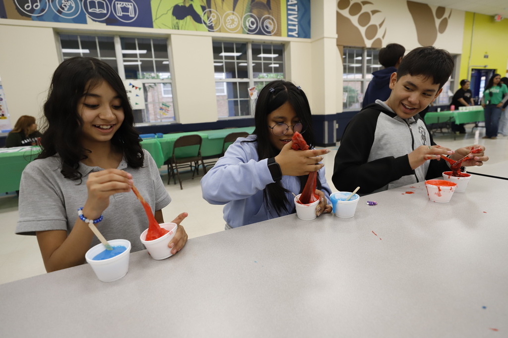 Guillen Middle School students making red and blue slime