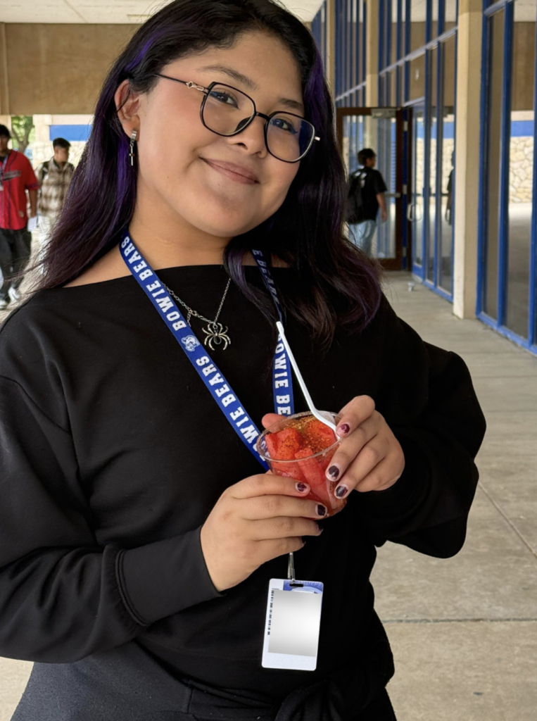 Student smiling with fruit cup for a photo