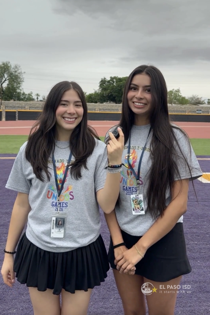 Two seniors from Coronado High School smile while holding mic
