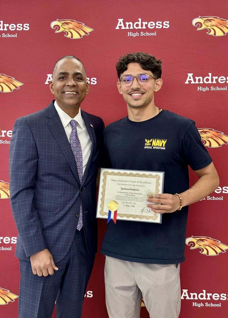 Mayor Renard Johnson takes photos with Andress High School's Joshua Kapoor after he receives the Team of Excellence Award