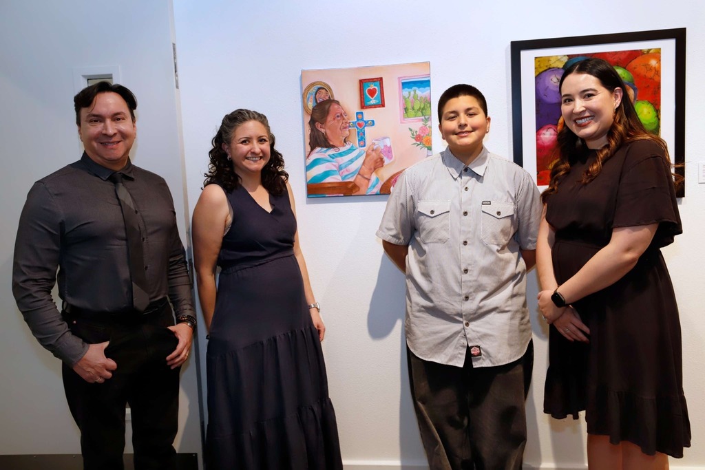 El Paso ISD staff members take photo with student artist and their artwork