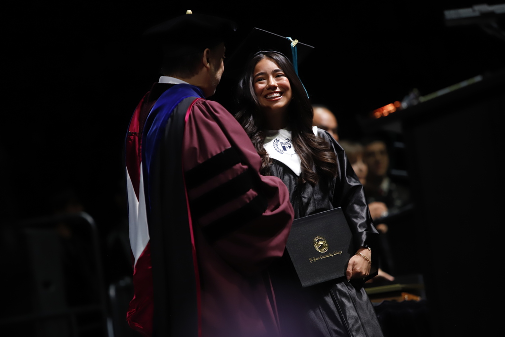 Coronado High School P-TECH student shakes EPCC presidents hand while receiving diploma