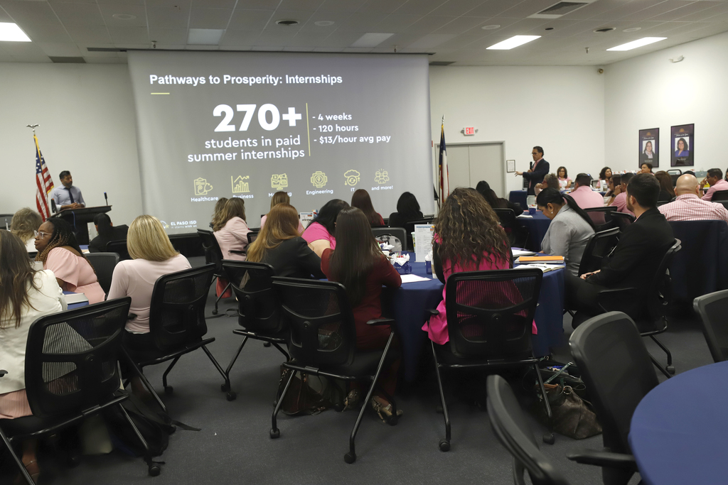 Photo of principals in meeting with Superintendent Dr. Brian Lusk presenting