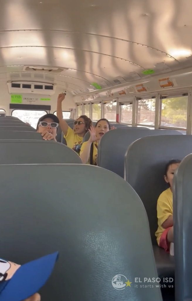 Photo of staff and students singing on bus