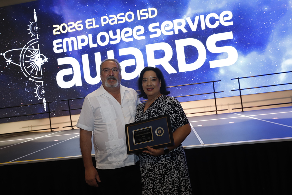 Staff members take photo with employee service award 