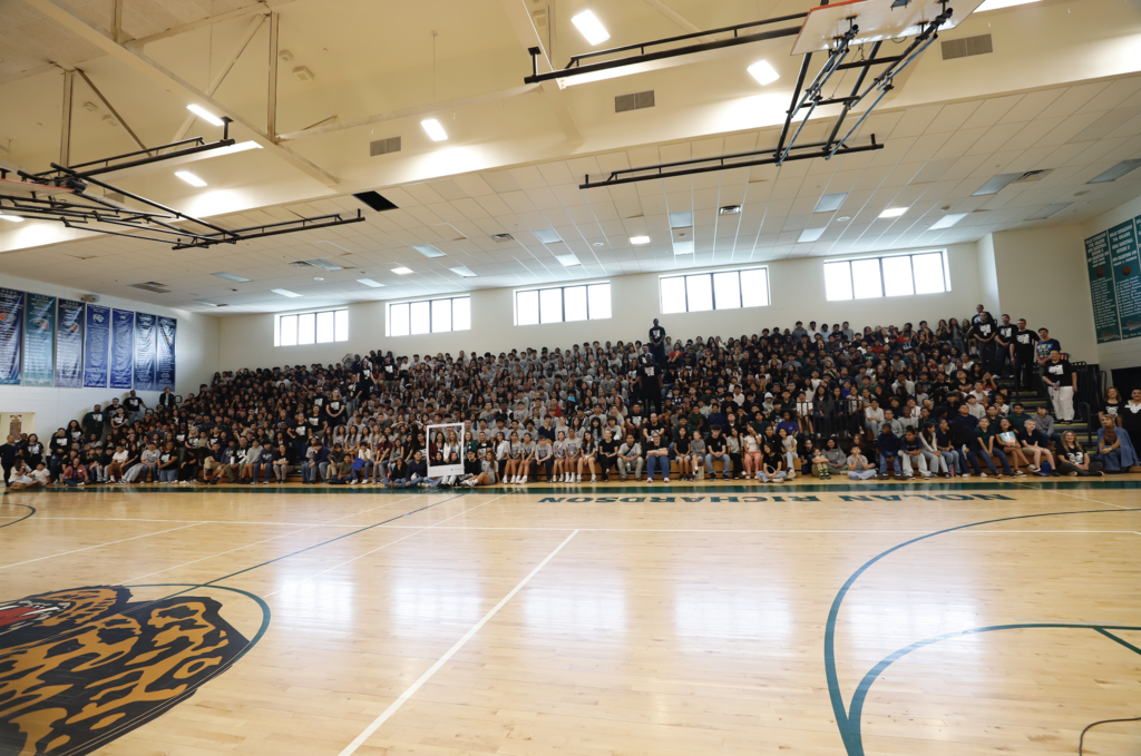 All of Richardson Middle School students and staff smile in Right Here Right Now giant polaroid