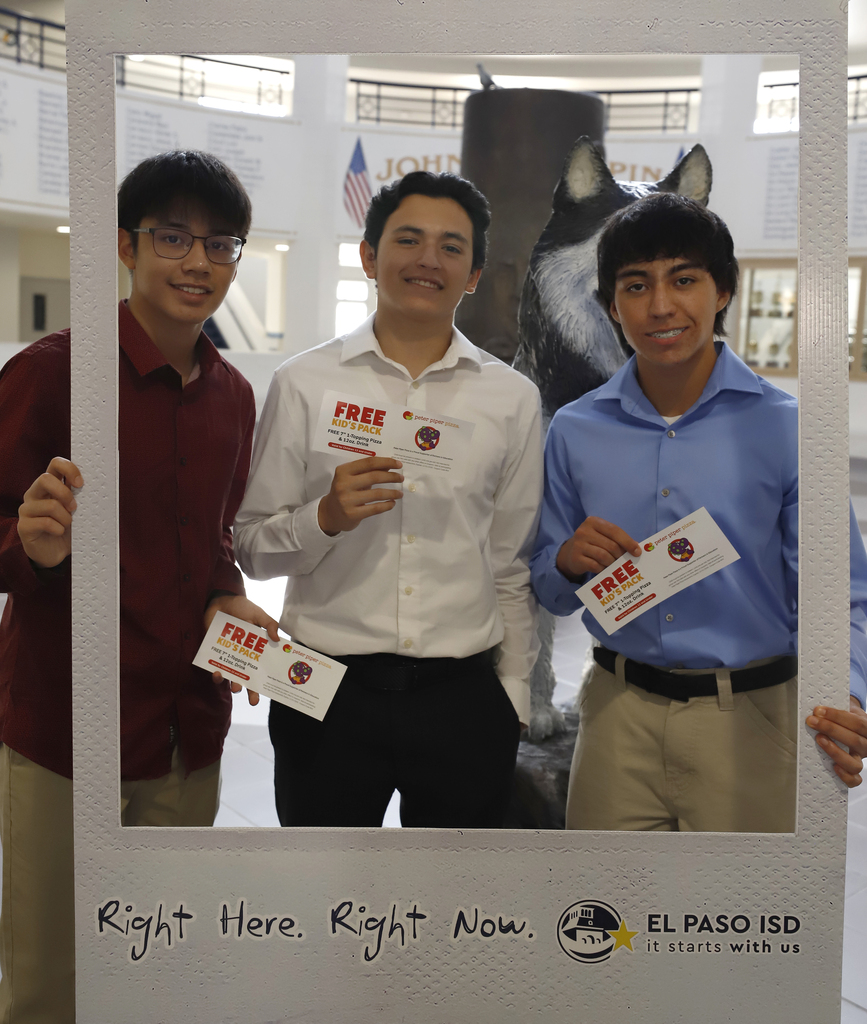 Chapin High School students smile in Right Here Right Now Giant Polaroid frame while holding Peter Piper Pizza certificates