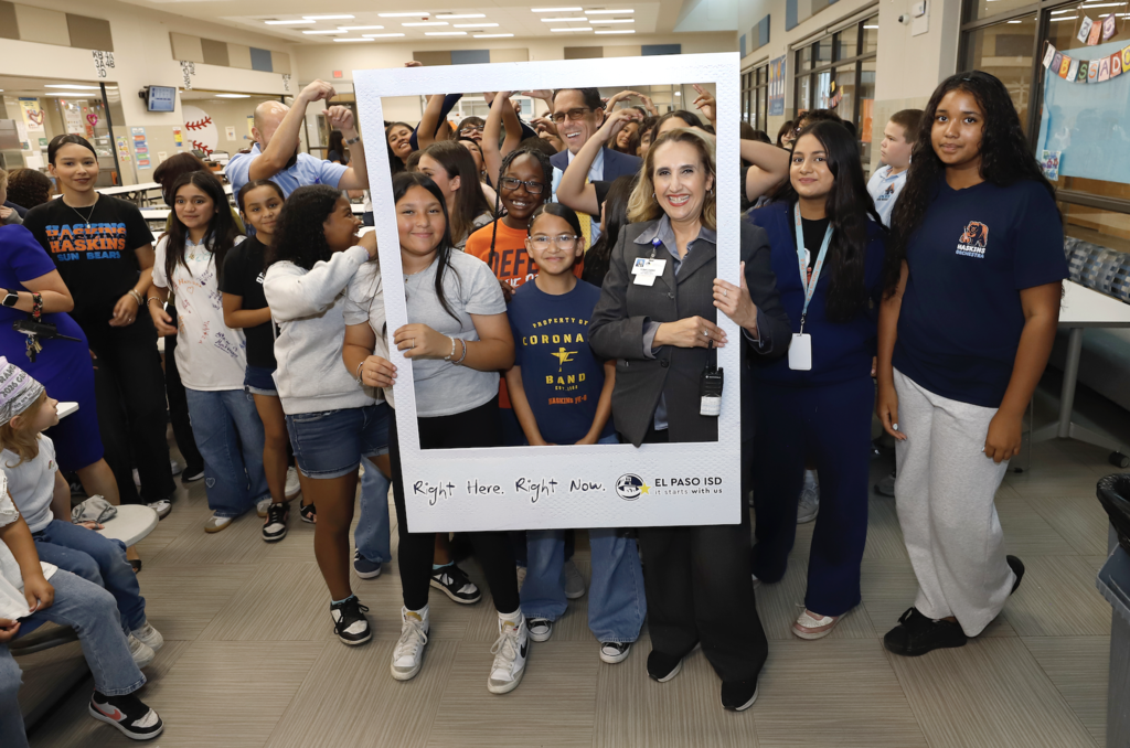 Don Haskins PK-8 students, staff, and Superintendent Dr. Brian Lusk take group photo in Right Here Right Now Giant Polaroid Frame