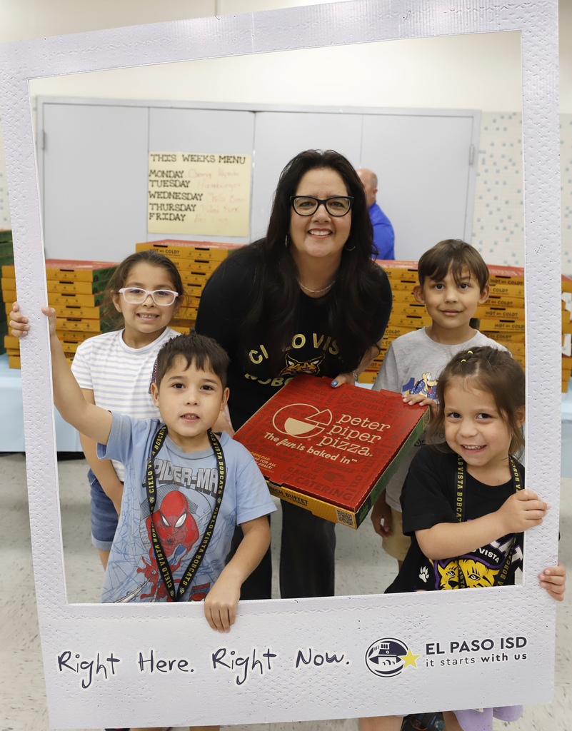 Cielo Vista Elementary School students and staff take group photo with principal in giant #RightHereRightNow polaroid frame