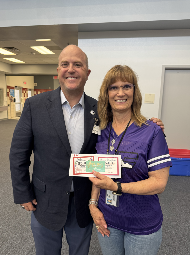 Attendance Challenge Franklin High School Staff winner takes photo with prize and education foundation manager Russel Booth