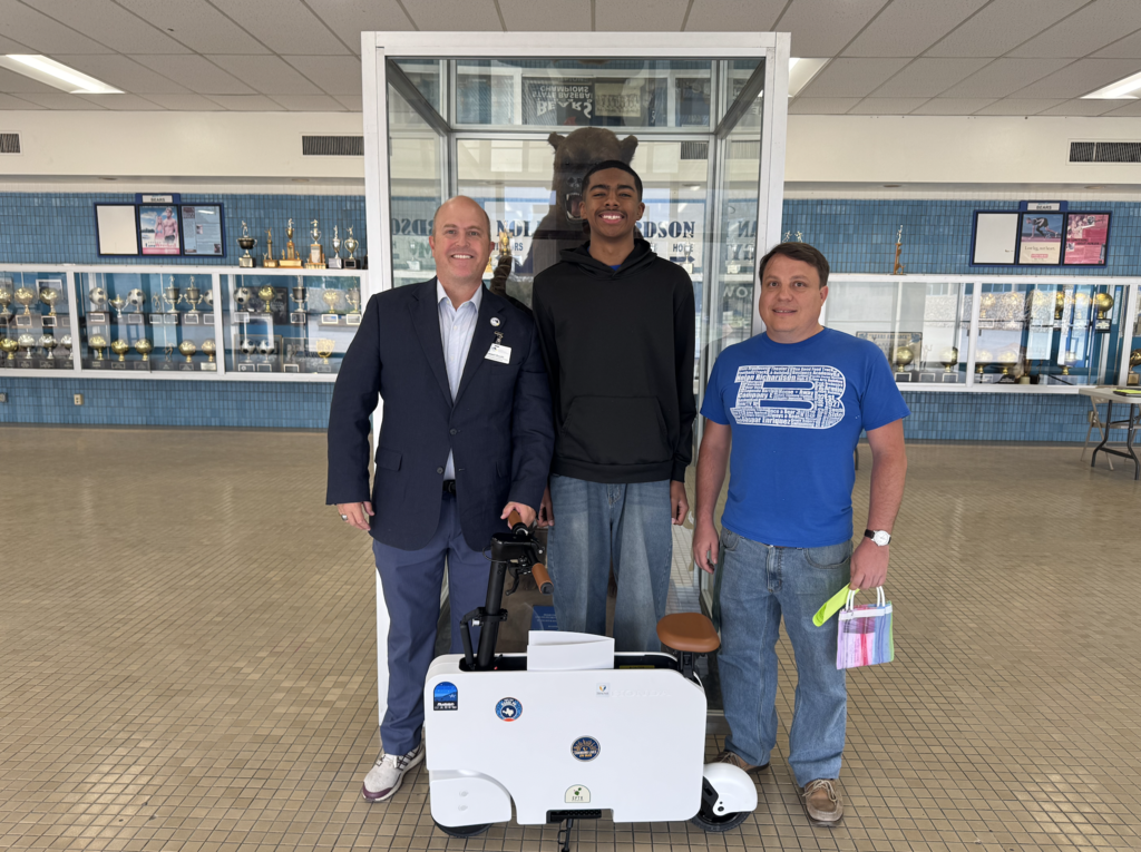 Attendance Challenge Bowie High School Student and staff winners takes photo with prizes and education foundation manager Russel Booth