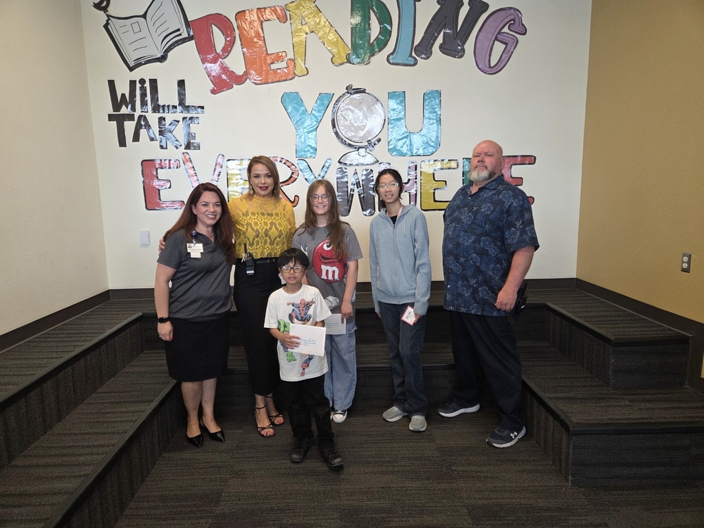 Attendance Challenge Student and staff winner takes photo with prize 