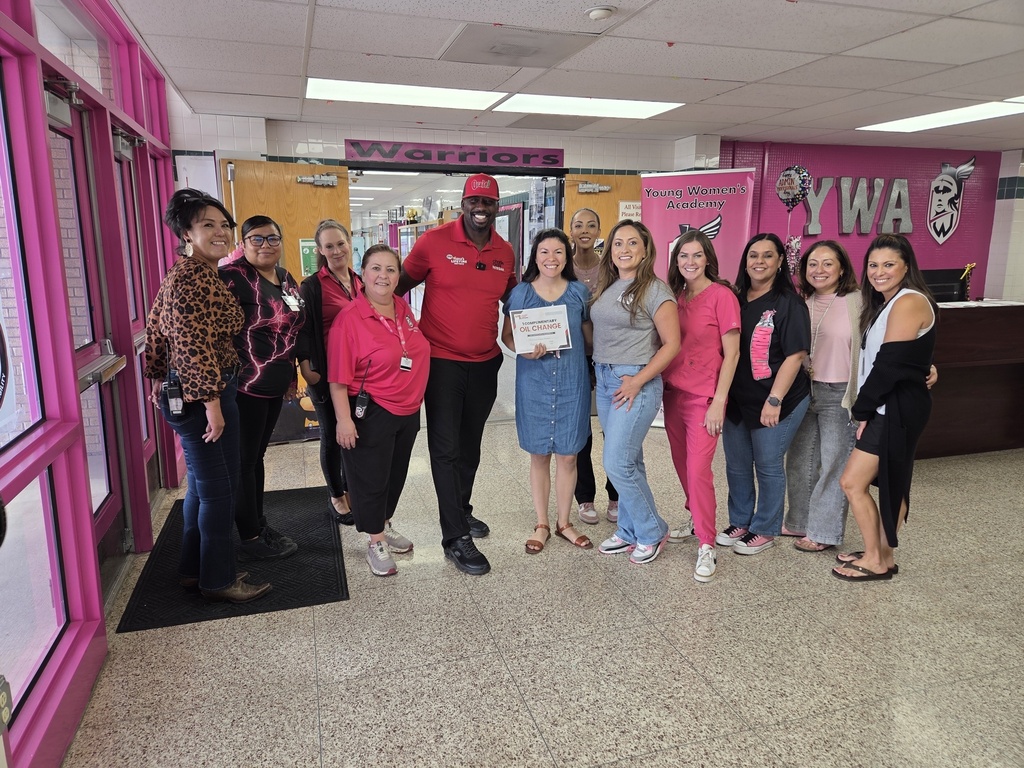 YWA staff celebrate Attendance Challenge Staff winner and takes photo with prize 
