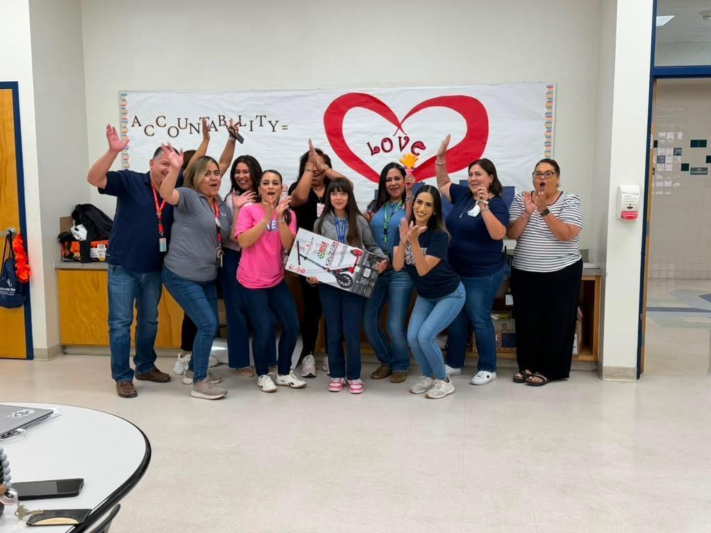 Attendance Challenge Student winner takes photo with prize and staff