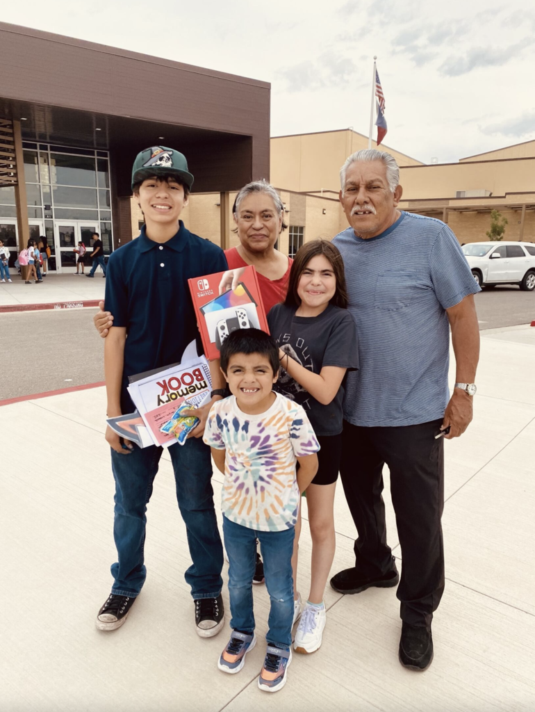 Attendance Challenge Student winners takes photo with prize and family