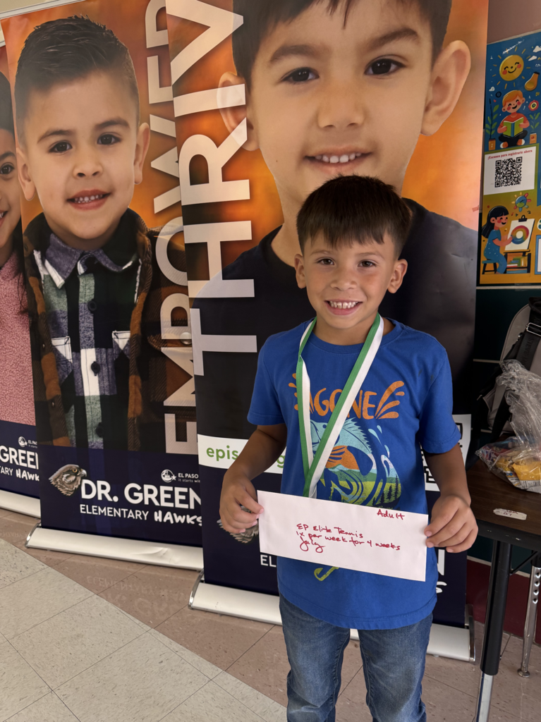 Attendance Challenge Student winner takes photo with prize 