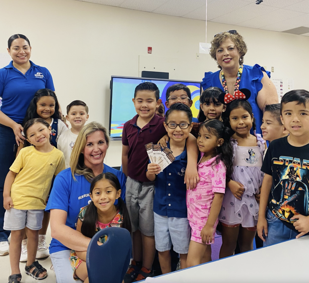 Attendance Challenge Student winner takes photo with prize and classmates