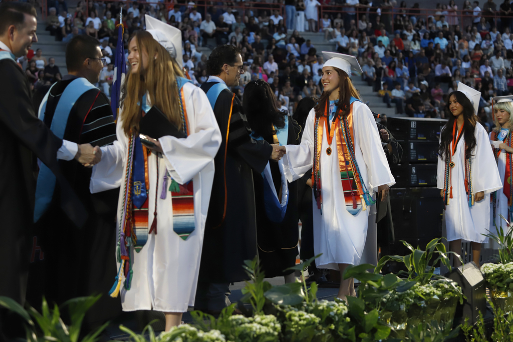 El Paso High School graduates shake hands with El Paso ISD staff and Superintendent Dr. Brian Lusk