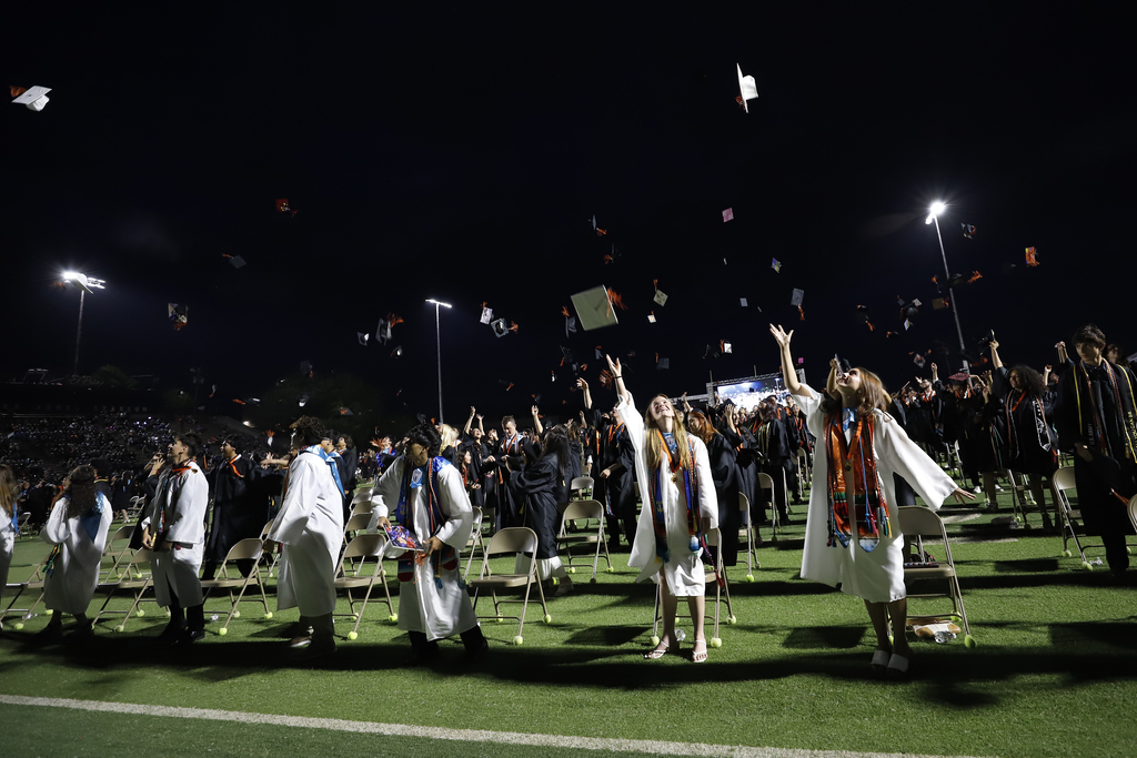 El Paso High School graduates throwing caps in the air