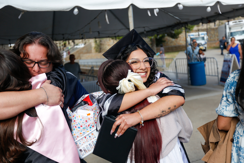 YWA graduate hugging family member after ceremony