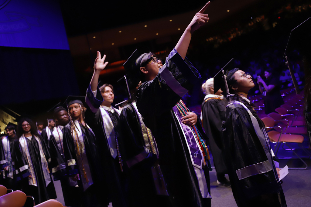 Franklin graduates walking into ceremony pointing