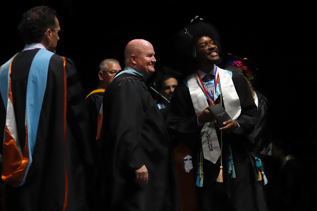 TMECHS grad smiles after receiving diploma
