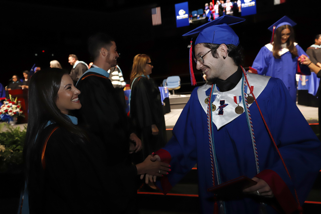 Irvin graduate shakes hand with feeder pattern principal