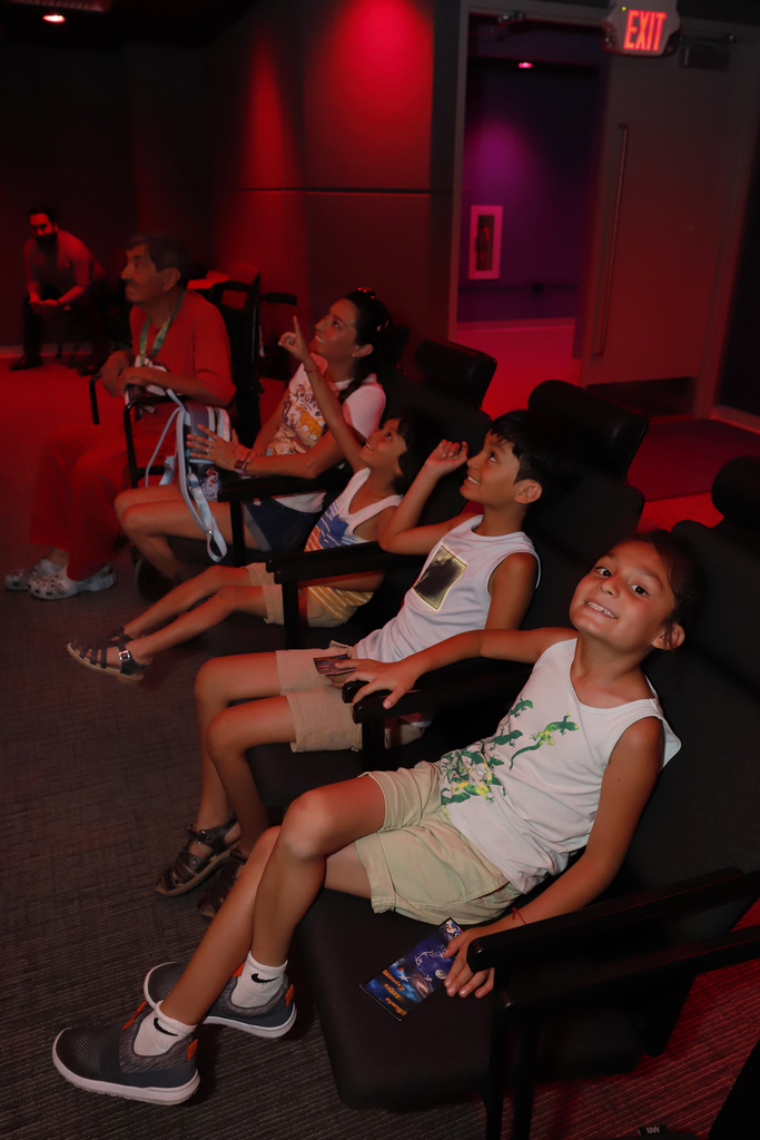 Family smilies looking up in the Gene Roddenberry Planetarium