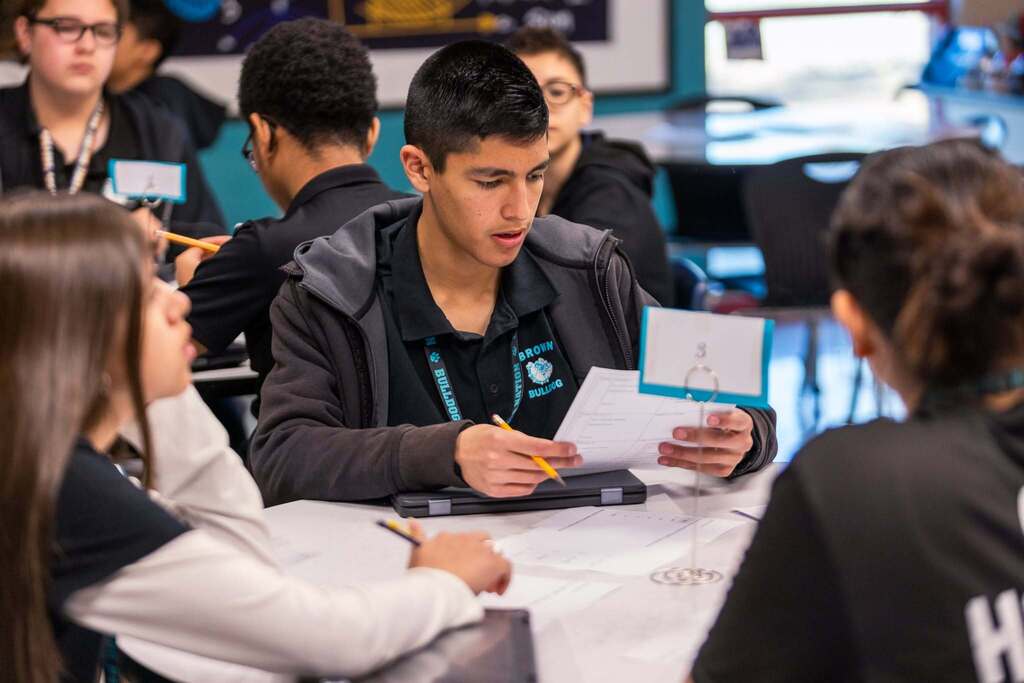 Student looking at paper while in class