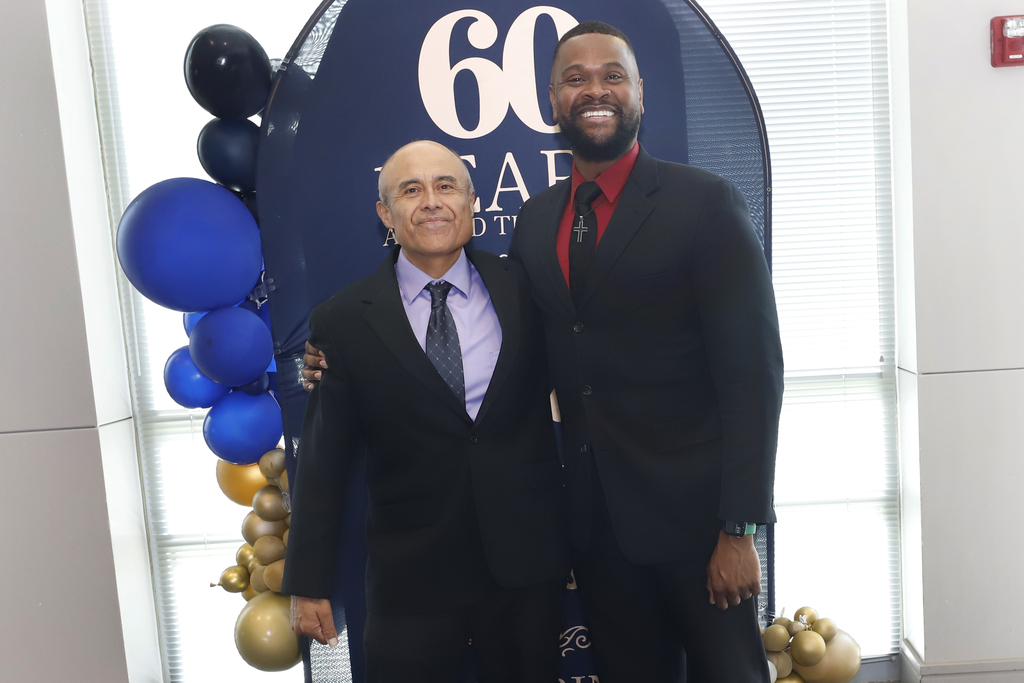 Ramon Rosales Jr. of Lundy Elementary School and John Matthews of Jefferson Silva High School smile for a photo