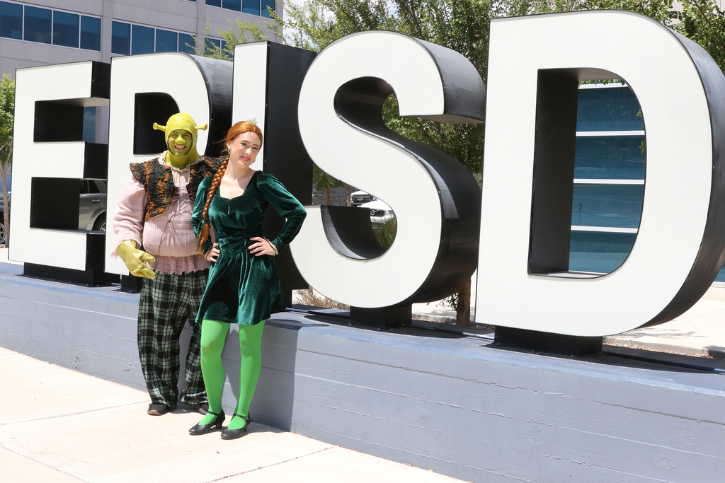 Photo of El Paso ISD Fine Arts students dressed in costume as Shrek and Fiona in front of central office giant EPISD letters