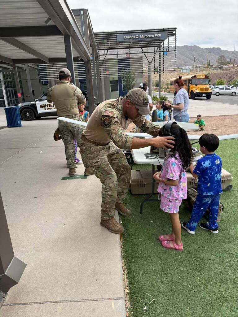 Military group presents to Murphree PK-8 students letting them try on gear