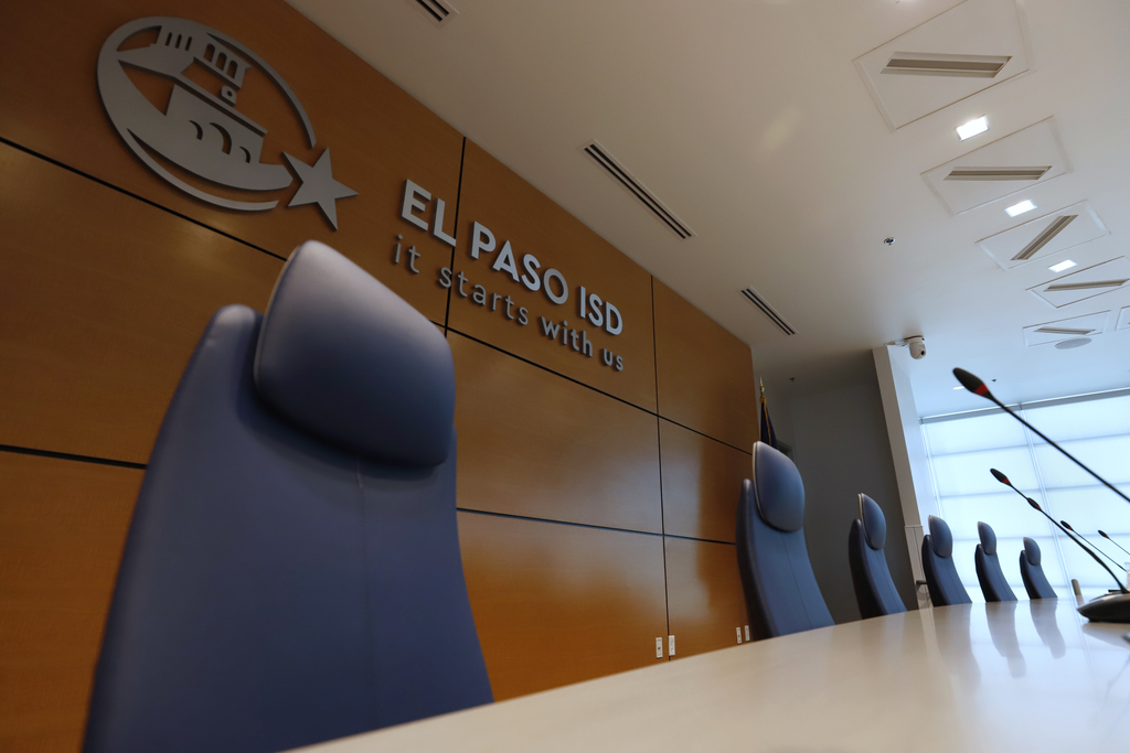 El Paso ISD Board Room close up of chairs with El Paso ISD It Starts With Us sign in the back
